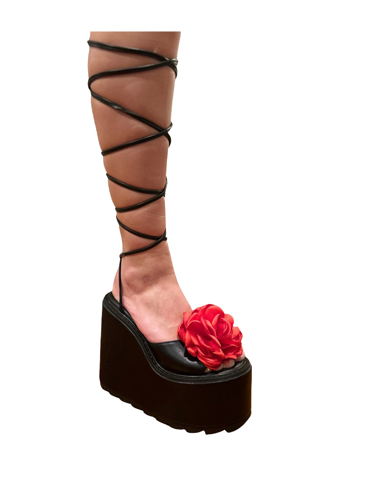 Black platform sandal with red flower on a white background